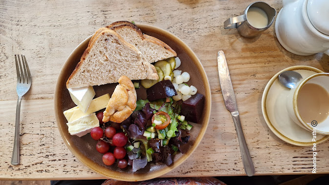 Ploughmans with Brie, Cheddar, salad, Porkpie, grapes, pickled gherkins, good quality sliced bread and amazing pickeld onions.