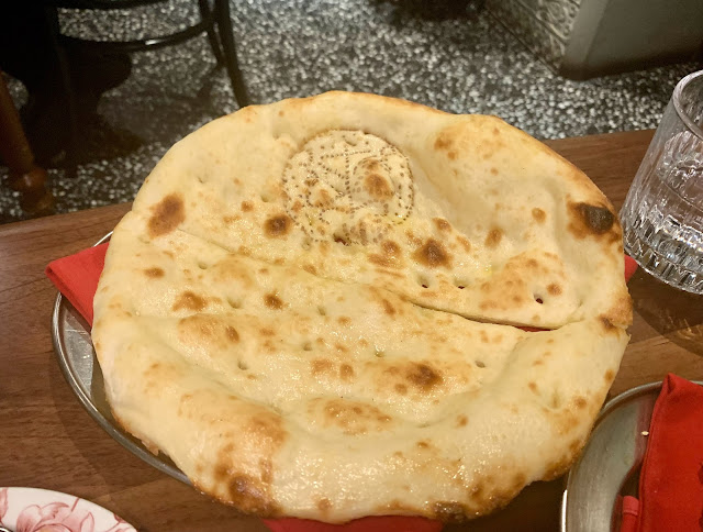 Whole saffron naan bread on a plate