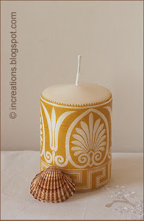 Decorative decoupage candle and a seashell