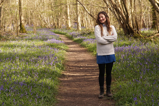 country girl in bluebell wood