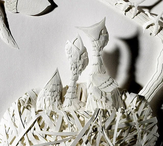 white paper sculpture nested robins feeding