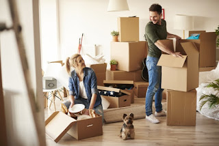 Young couple and their pet in a new apartment