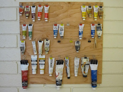 Mike is Bored: Paint tube display and storage rack on wall.