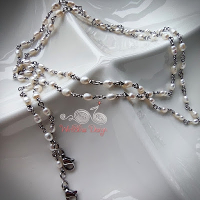 Wire wrapped rice pearl face mask chain on a white dish