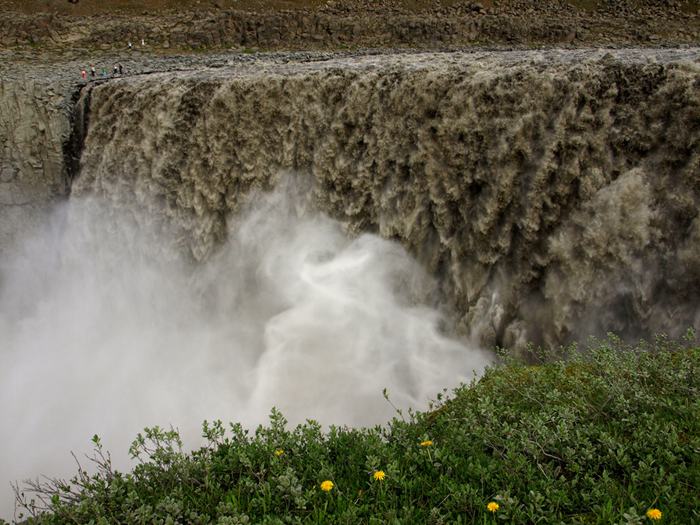 The waterfall Dettifoss is located in Vatnajökull National Park in Northeast Iceland, and reputed to be the most powerful waterfall in Europe. It is also the largest waterfall in Europe in terms of volume discharge, having an average water flow of 193 cubic meter per second. Its volume often increases, especially when the weather or volcanic activity prompts glacial melting on the Vatnajokull glacier icecap. The waterfall is so powerful that it makes the surrounding rocks vibrate, the vibrations can be felt by hand.