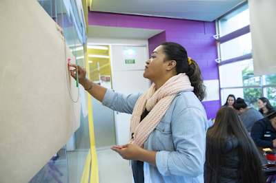 Woman writing on whiteboard