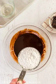 adding powdered sugar to chocolate mixture
