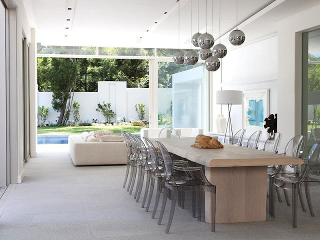 Dining room with wooden table and glass chairs 