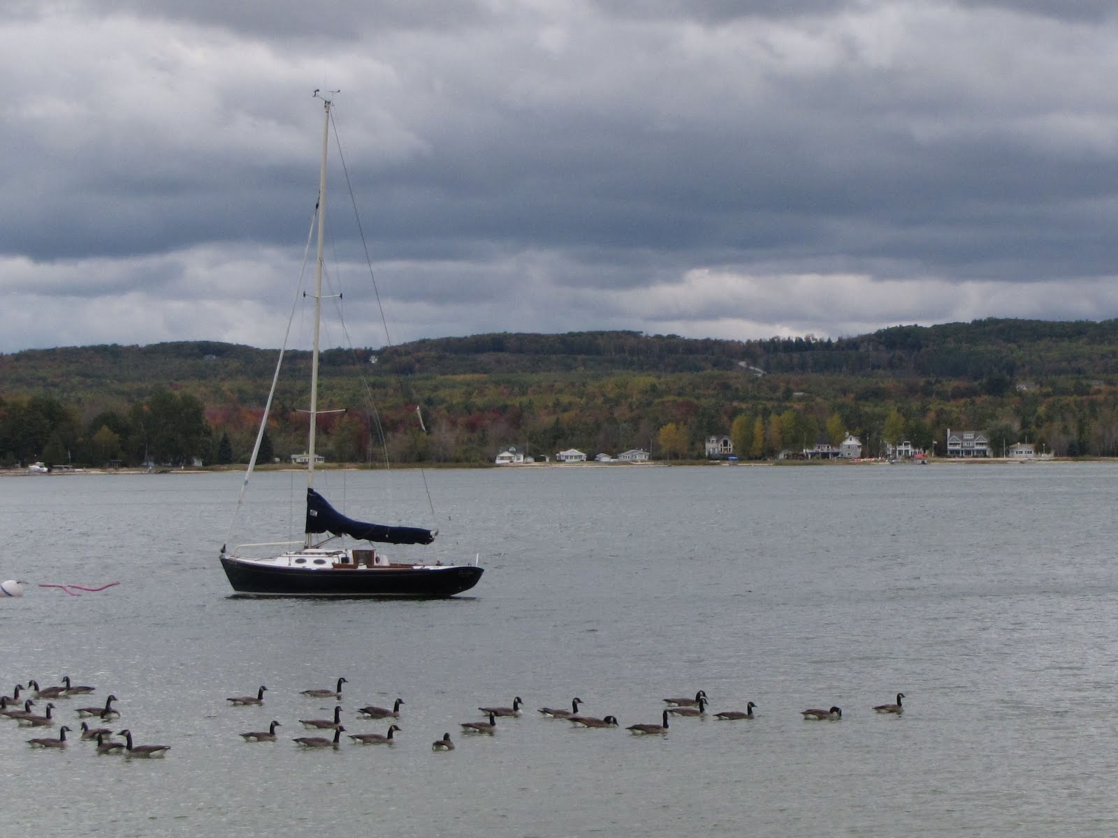 sailboat on a gray lake