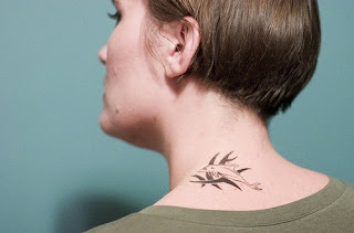 Dolphin art tattoo design on girl's neck