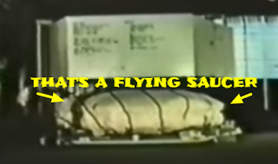 Flying Saucer under a cover been transported in a box.