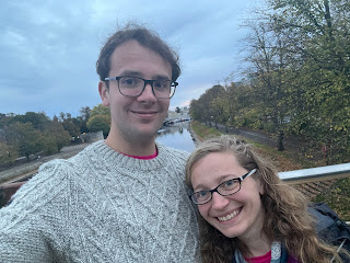 A selfie of me and John smiling on a pedestrian bridge on the River Ouse.