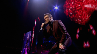 George Michael singing, heart background. London, 2008.