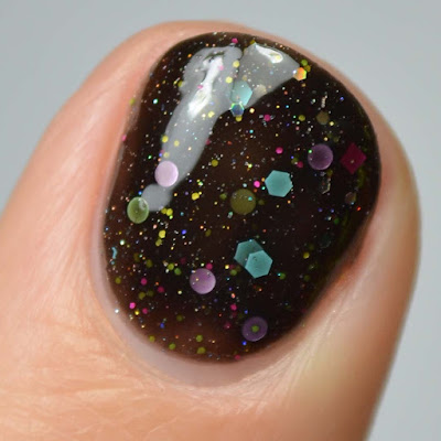 black nail polish with rainbow glitter swatch