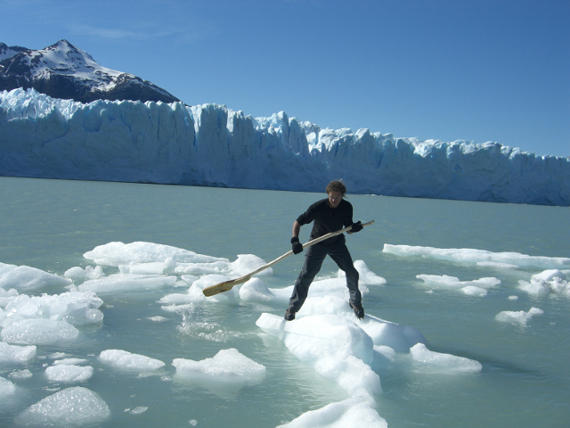Using an iceberg as a stand up paddle board Perito Moreno Glacier Patagonia