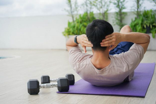 Gerakan yang benar saat melakukan teknik dasar sit up adalah?