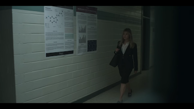 Screenshot from Awake 2021, showing hallway with posters on right.