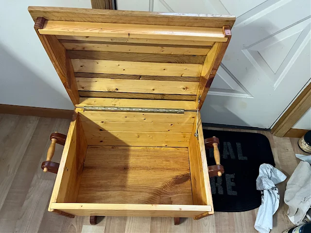 Photo of a wooden storage/blanket chest from Goodwill.
