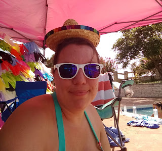 Woman in a swimsuit wearing sunglasses and a tiny sombrero