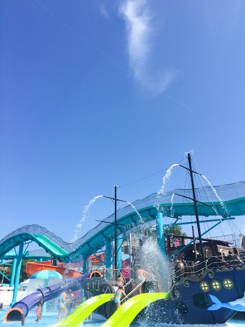A giant ship spouts gallons of water on guests young and old. 