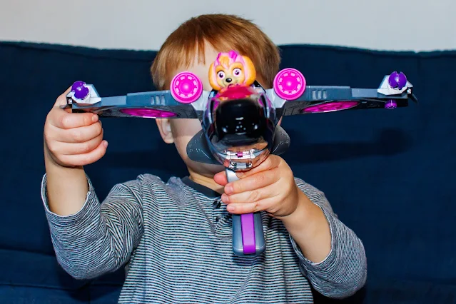 The Mighty Jet in front of a child's face ready to fire a projectile