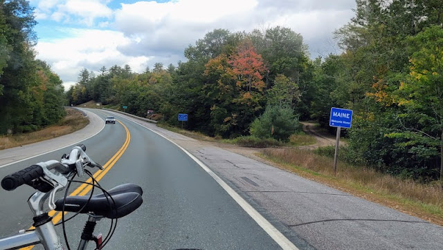 The road ahead with Maine sign.