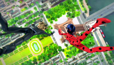 View from above as Cat Noir (l) and Ladybug fall past the Eiffel Tower towards Paris