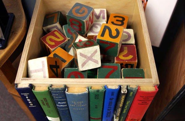 http://freshome.com/2012/06/25/hiding-clutter-behind-book-spines-modern-library-storage-bin/