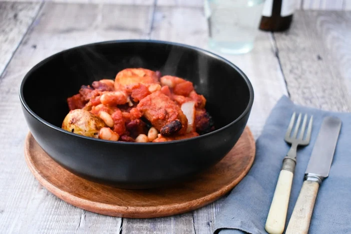 A black bowl with Vegan Cowboy Beans & Potato Bake