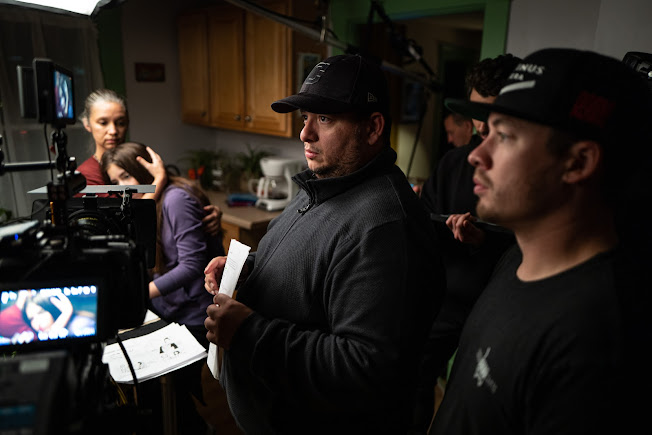 Director Fernando Lopez surrounded by cast and crew on 'Culantro Fino' set