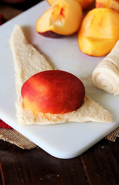 Rich crescent scroll dough wraps around in addition to embraces fresh peach quarters to create piffling p Crescent Roll Peach Dumplings