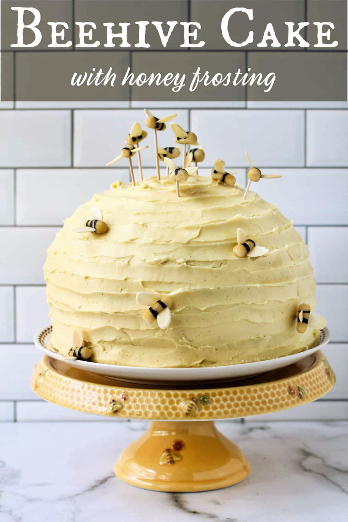 Beehive Cake with marzipan bees on a cake stand.