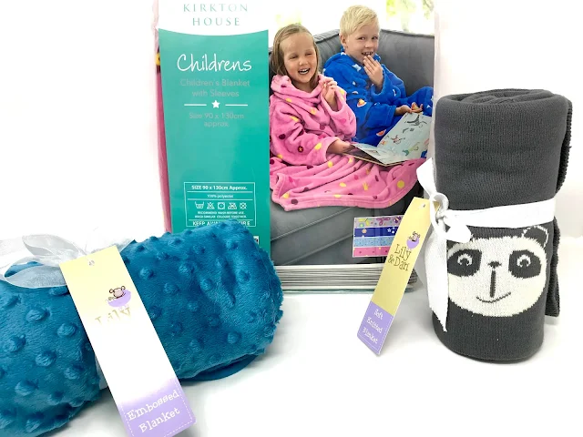 A binky fabric blue blanket, a grey tight knitted blanket and a pink children's blanket with arms