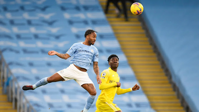 Man city forward Raheem Sterling and Fulham defender Ola Aina in action in the Premier League