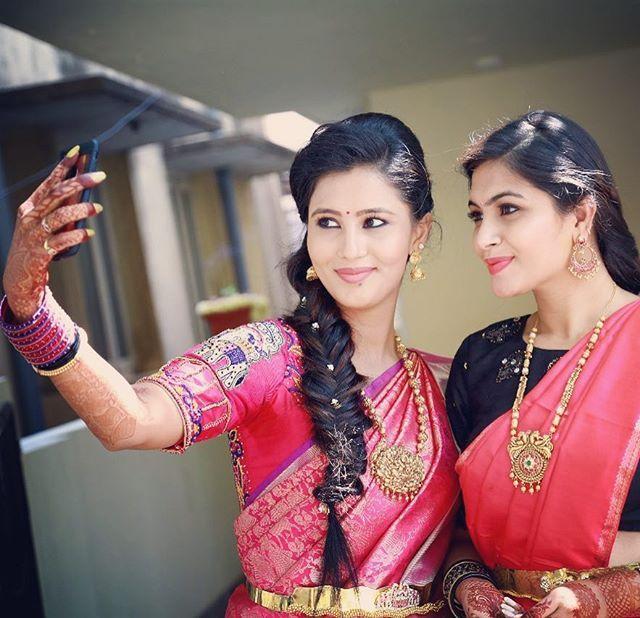 Sonu Gowda in a stunning red saree, radiating elegance and grace.