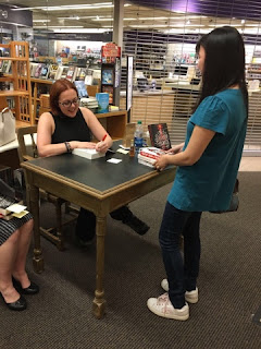 Victoria signing my books~