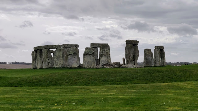 The grey, mottled rocks of Stonehenge echo a lighter but equally mottled grey sky and contrast with the rolling green grass that they stand magnificently upon