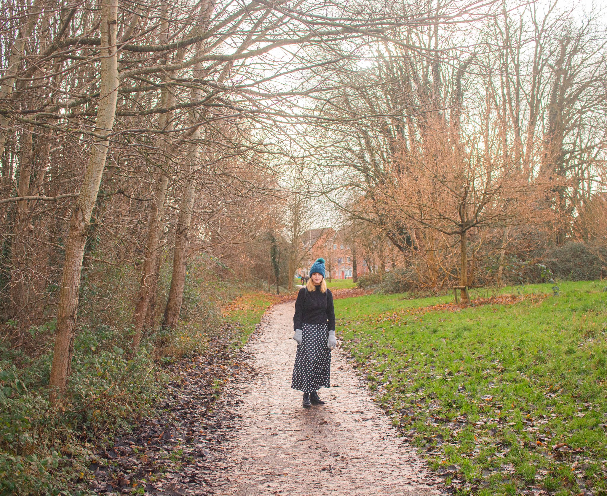 fashion blogger chloeharriets wearing polka dress, jumper and hat, walking through nature, smiling, how to relieve stress blog self-care intentional living