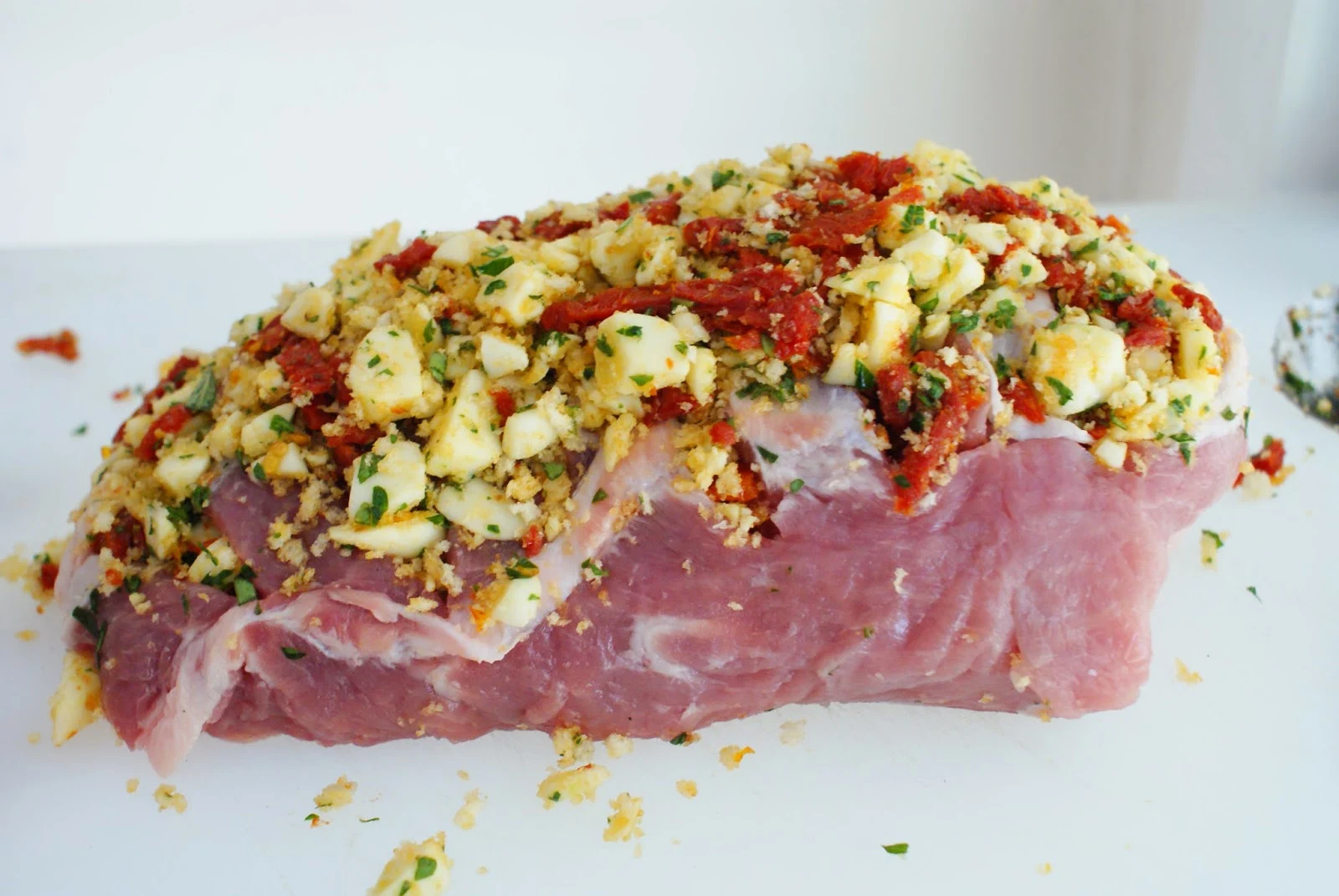 Roast Pork Loin Stuffed with Sun-Dried Tomatoes and Mozzarella Cheese before roasting in the oven.