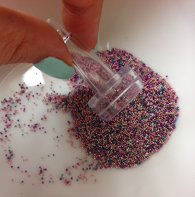 Using funnel to scoop up beads