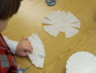 Cutting coffee filter snowflakes (Brick by Brick)