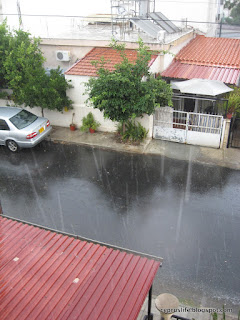 Raindrops falling in the street, torrential rain in Cyprus in September