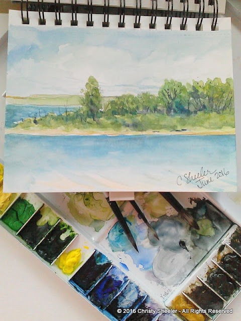 Watercolor sketch done at the lake.  Travel palette holds the watercolor mixes.