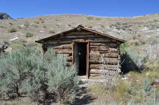 log cabin with an open door