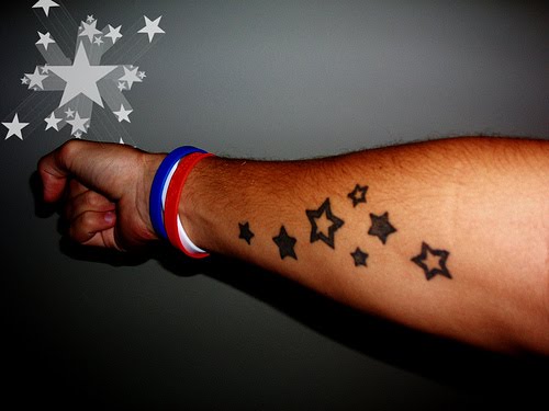 Seven stars tattooed on forearm.
