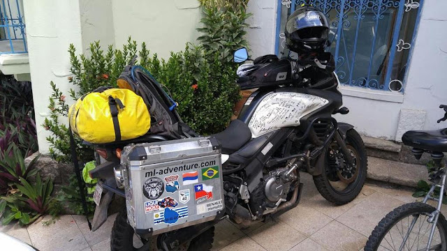 white suzuki v-strom 650ccm with luggage and side boxes