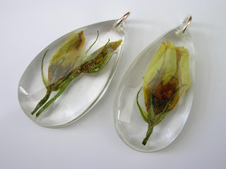 Clear resin teardrop pendant containing preserved wedding flowers