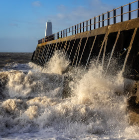 Photo of powerful waves breaking against Maryport pier