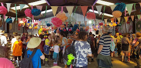 Our Kids Social Big Barn Flamingo Lounge Disco full of people in bold clothing dancing