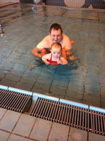 Baby Sophia swimming with a float with her dad 